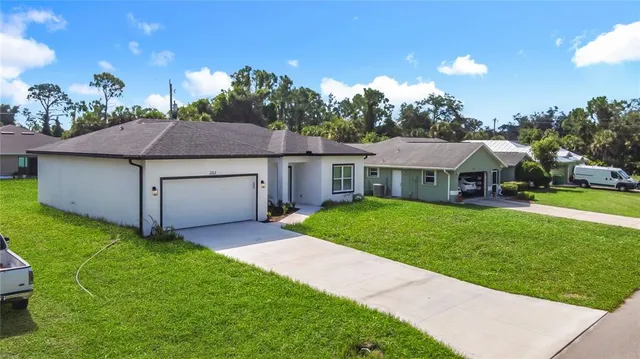 a aerial view of a house with a yard and garage