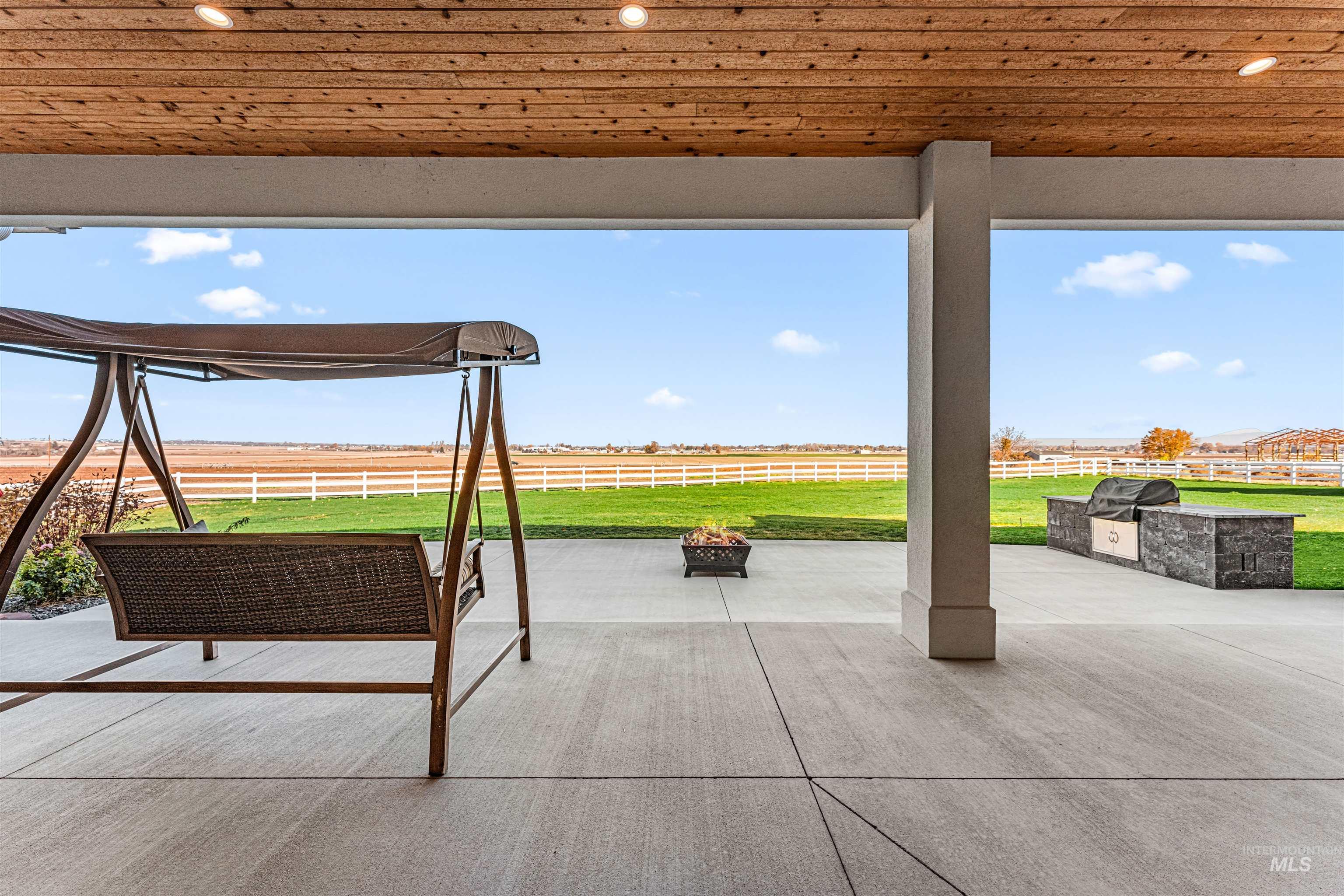 12334 Rivendell Court Nampa, ID 83686 - Photo 47 of 50 View of patio with an outdoor fire pit, grilling area, and a rural view