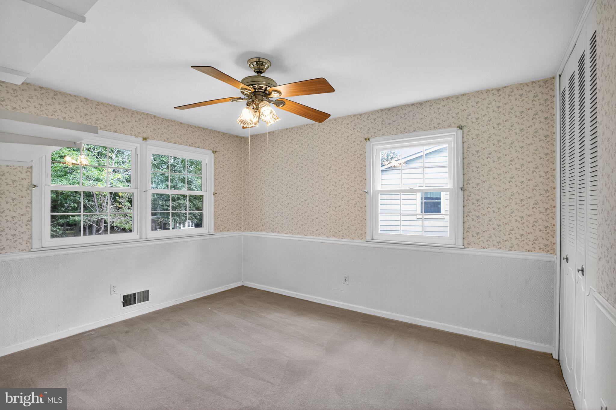 7374 Roxbury Avenue Manassas, VA 20109 - Photo 12 of 42 an empty room with a window and a fan