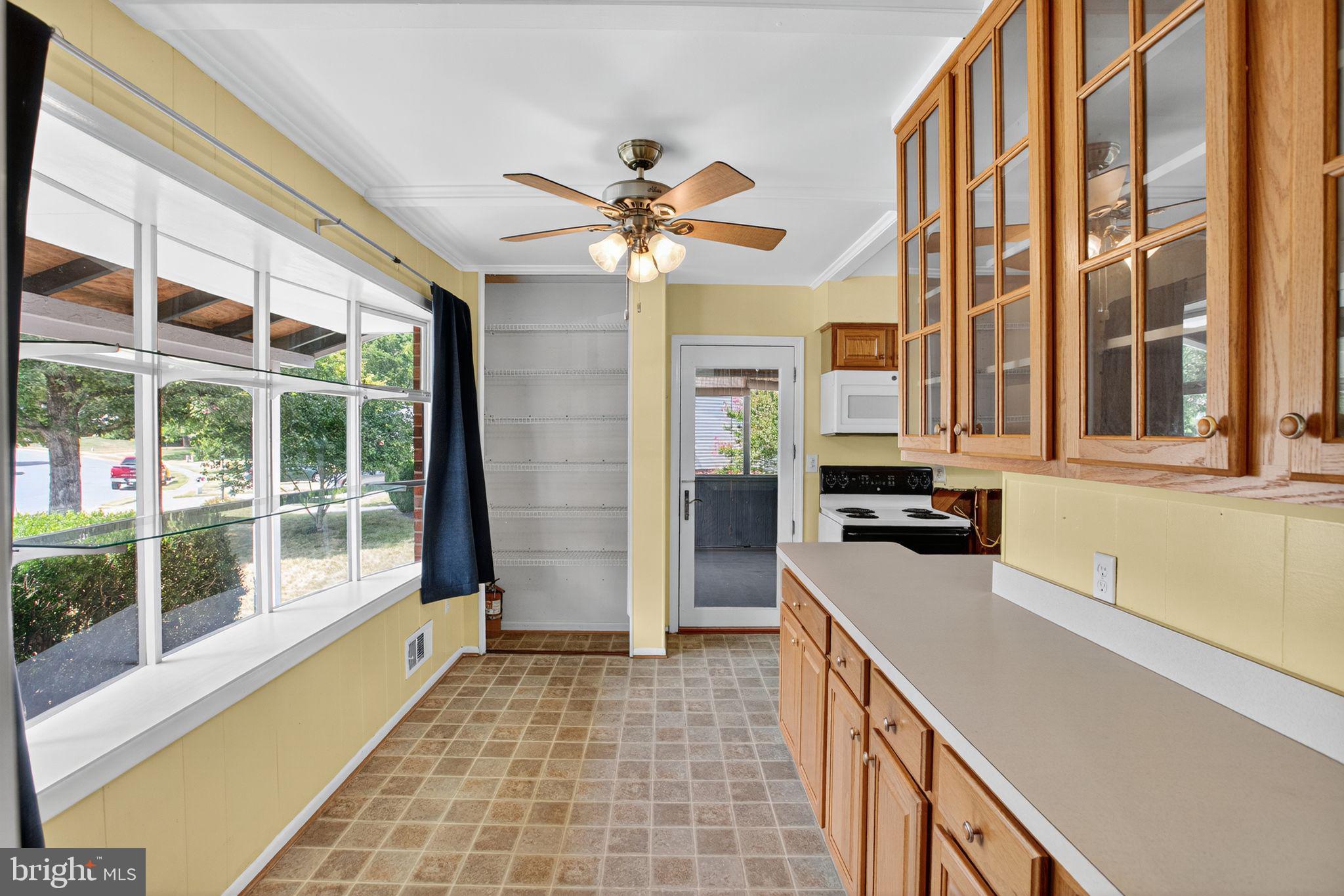 7374 Roxbury Avenue Manassas, VA 20109 - Photo 16 of 42 a kitchen that has a lot of windows and brick walls
