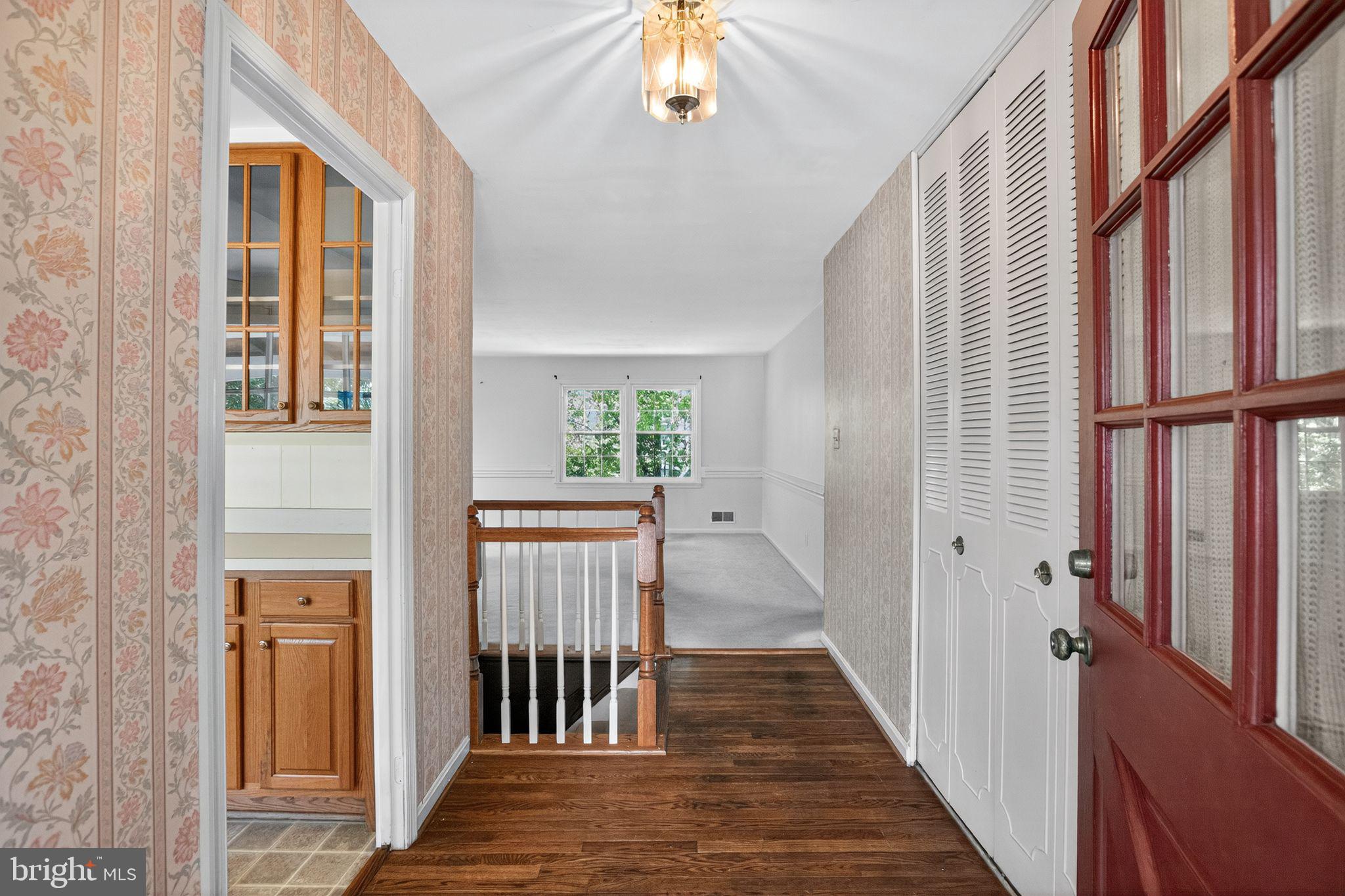 7374 Roxbury Avenue Manassas, VA 20109 - Photo 2 of 42 a view of a hallway with wooden floor and staircase
