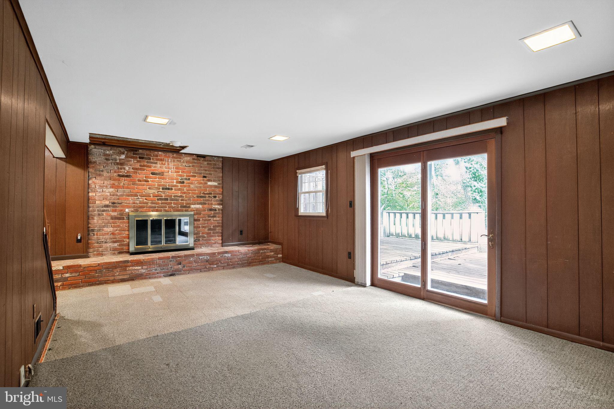 7374 Roxbury Avenue Manassas, VA 20109 - Photo 27 of 42 a view of an empty room with a fireplace and a window