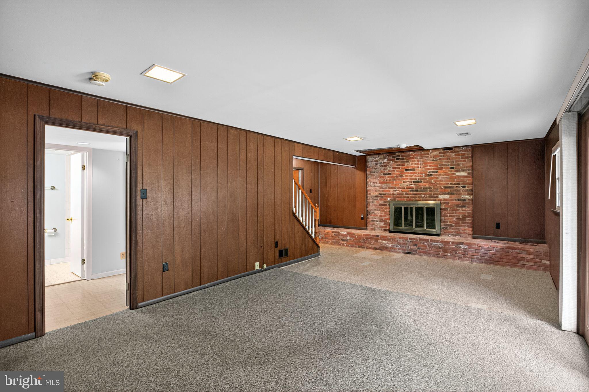 7374 Roxbury Avenue Manassas, VA 20109 - Photo 28 of 42 an empty room with windows and fireplace
