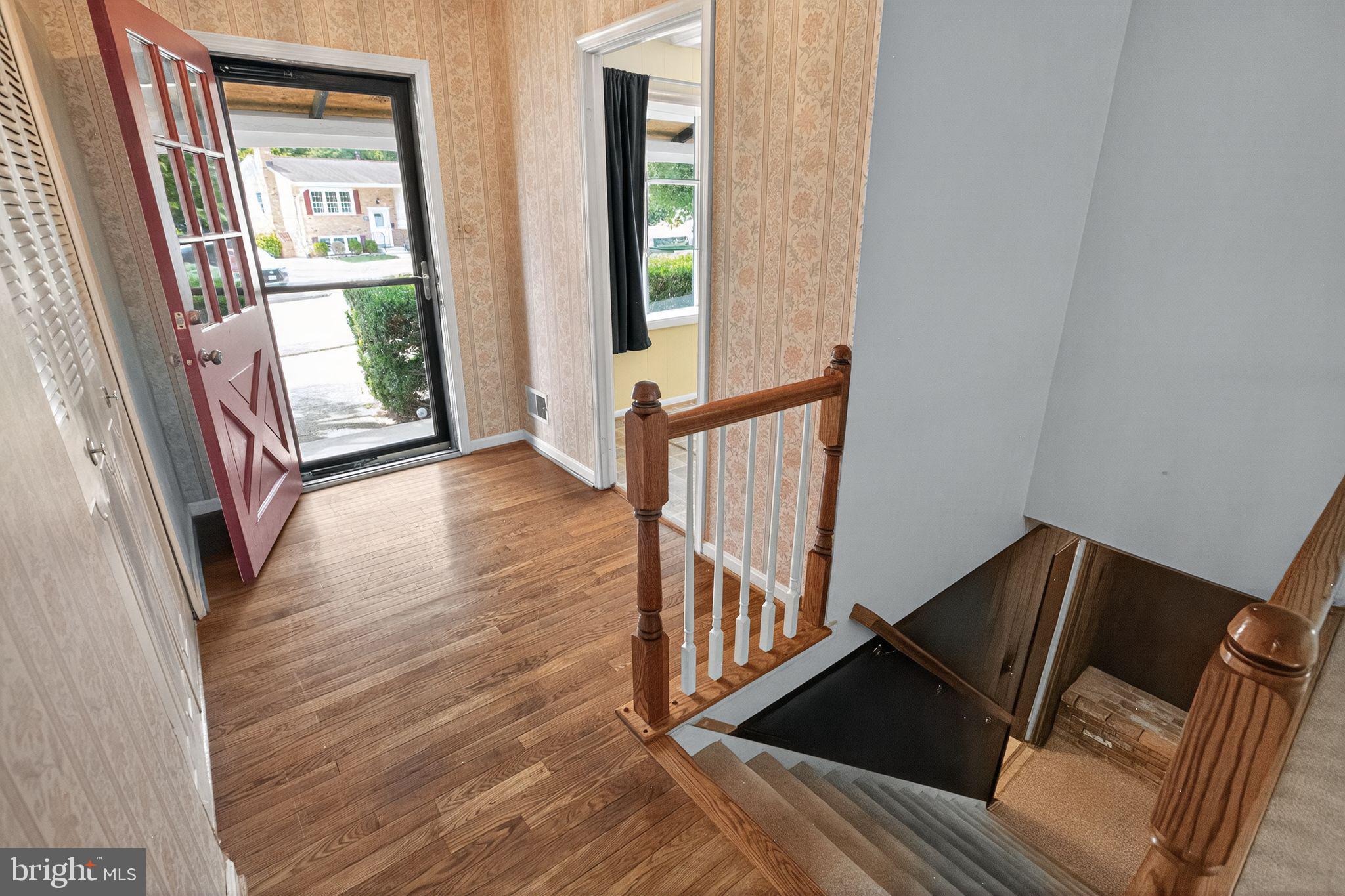 7374 Roxbury Avenue Manassas, VA 20109 - Photo 3 of 42 a view of a hallway with wooden floor and stairs