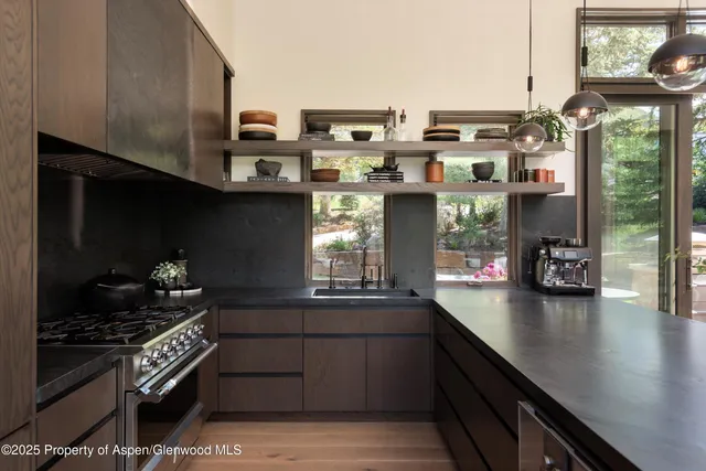 a kitchen with stainless steel appliances granite countertop a stove and a sink