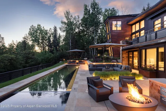 a view of swimming pool with seating area and furniture