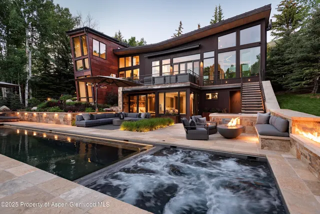 a view of a house with pool and sitting area