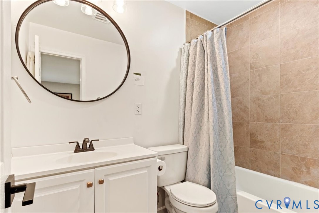 517 West Riverside Drive Lanexa, VA 23089 - Photo 21 of 31 a bathroom with a sink a toilet and a mirror