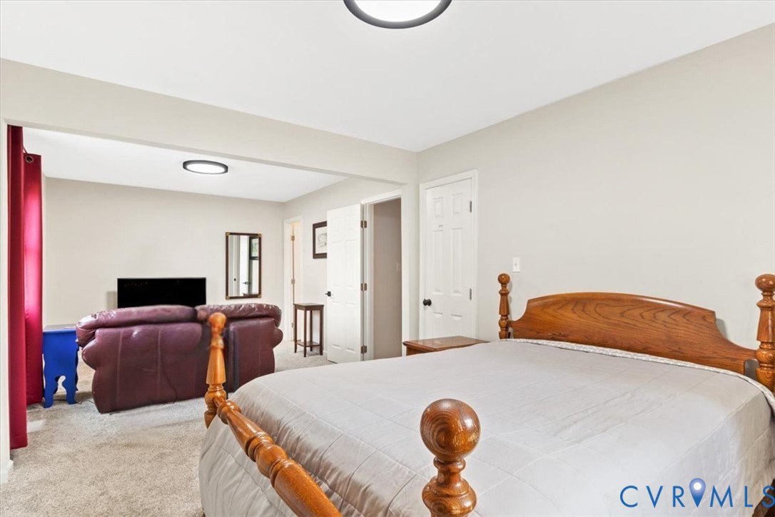 517 West Riverside Drive Lanexa, VA 23089 - Photo 22 of 31 a bedroom with a bed and wooden floor