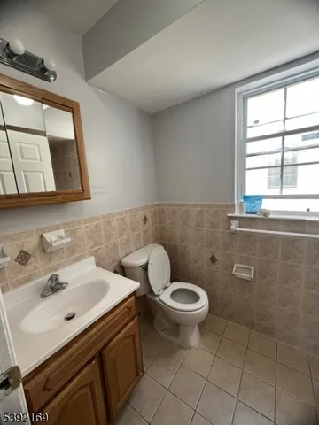 a bathroom with a sink toilet and mirror