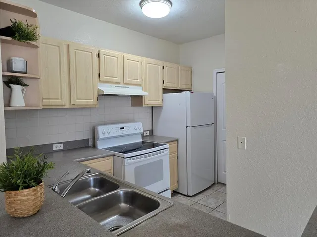 a kitchen with a sink and a refrigerator