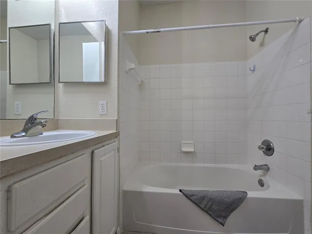 a bathroom with a granite countertop toilet sink and mirror