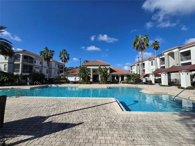 a view of a cafe with a table and chairs under an umbrella