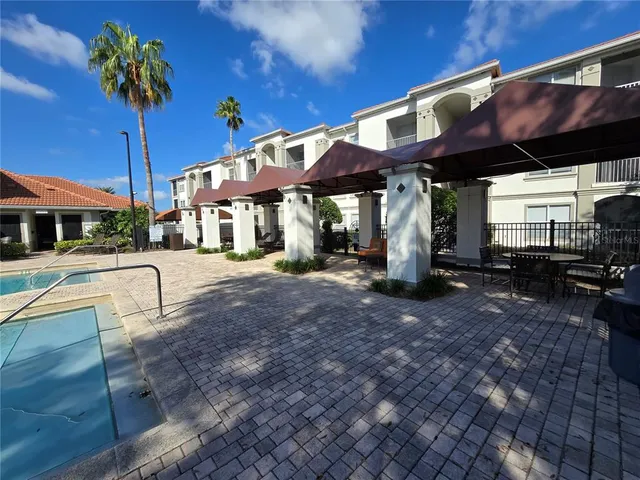 a front view of a house with a lots of potted plants
