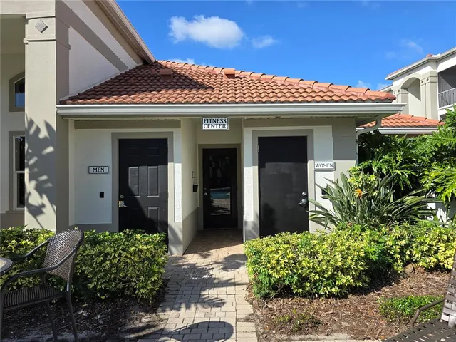 a view of a room with gym equipment and white walls