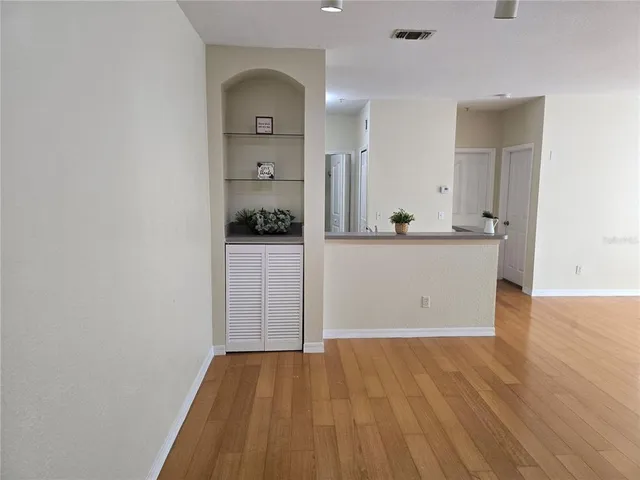 wooden floor in an empty room and a kitchen