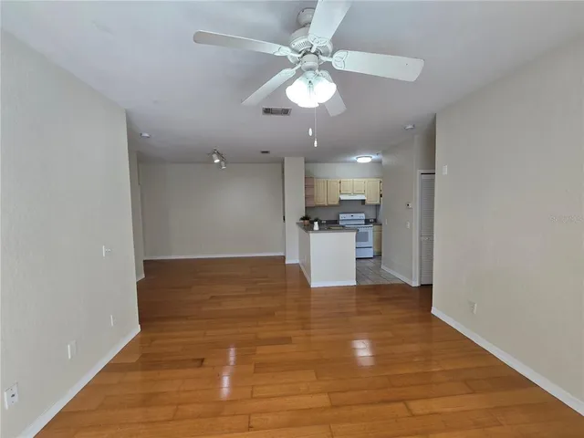 a view of a kitchen with a stove cabinets and wooden floor