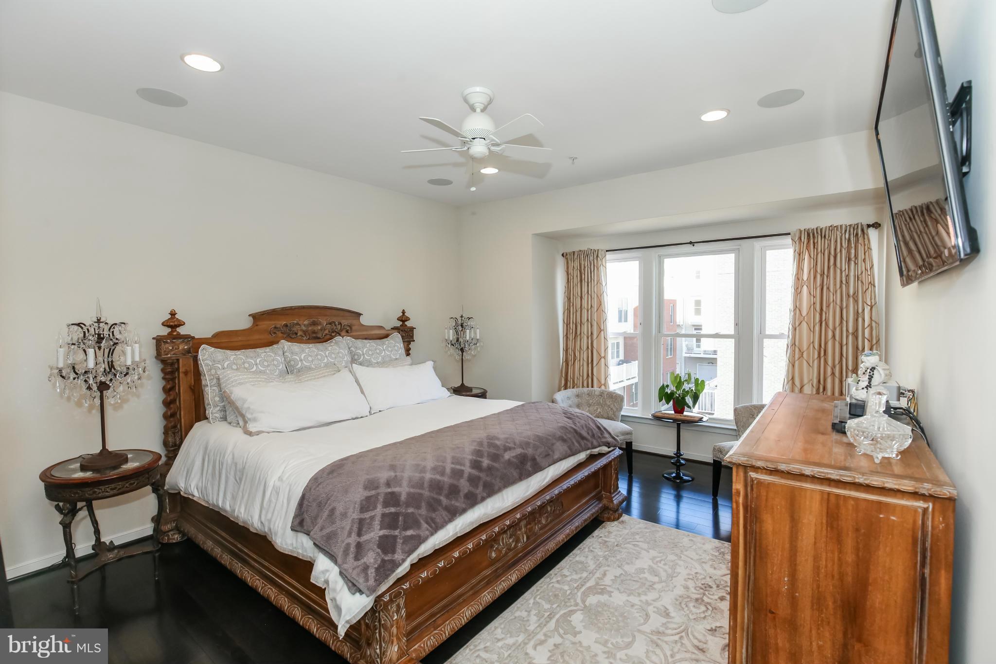 312 L Street Southeast Washington, DC 20003 - Photo 15 of 29 a bedroom with a bed and a chandelier