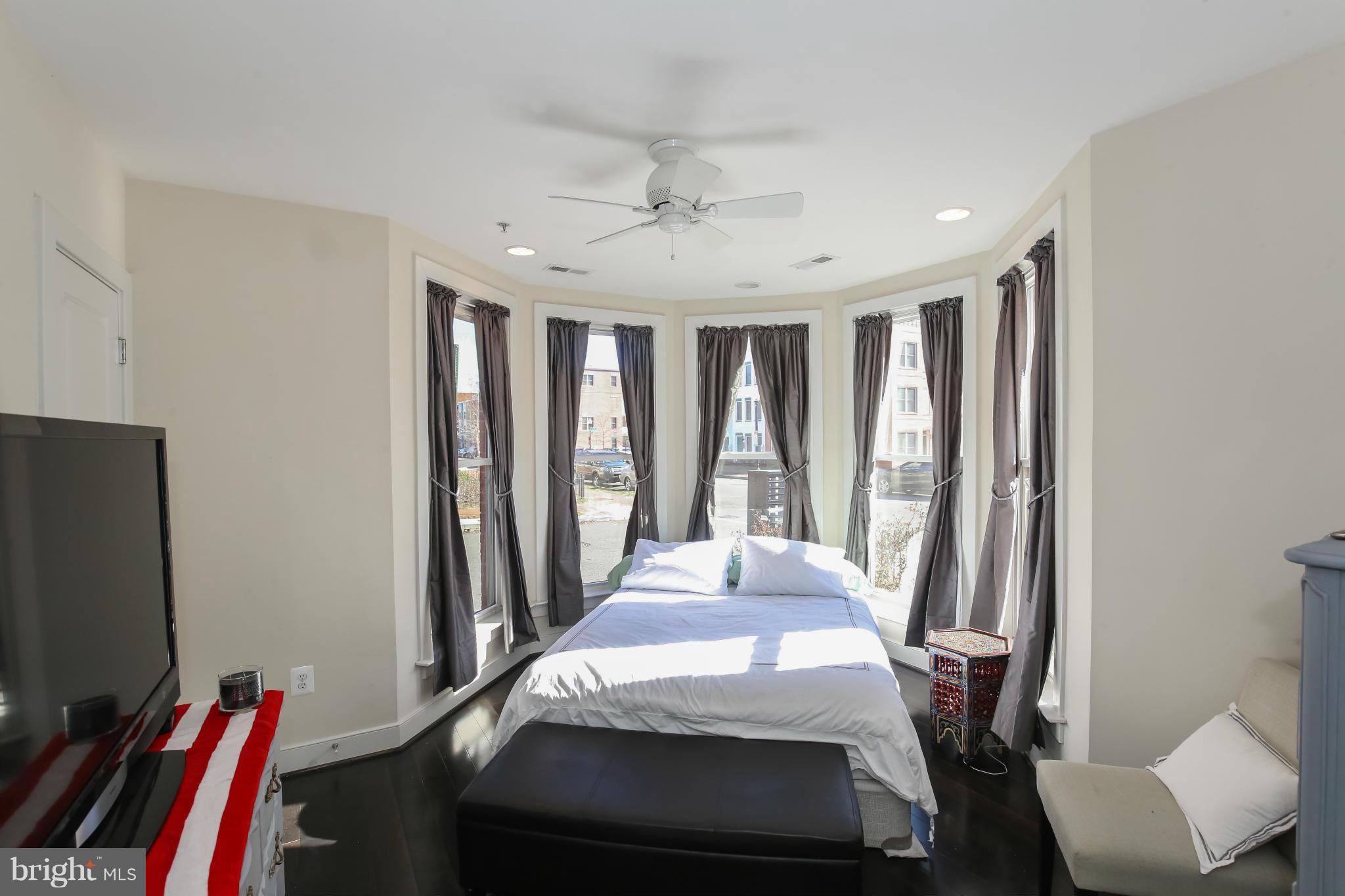 312 L Street Southeast Washington, DC 20003 - Photo 4 of 29 a bedroom with a bed and a flat screen tv