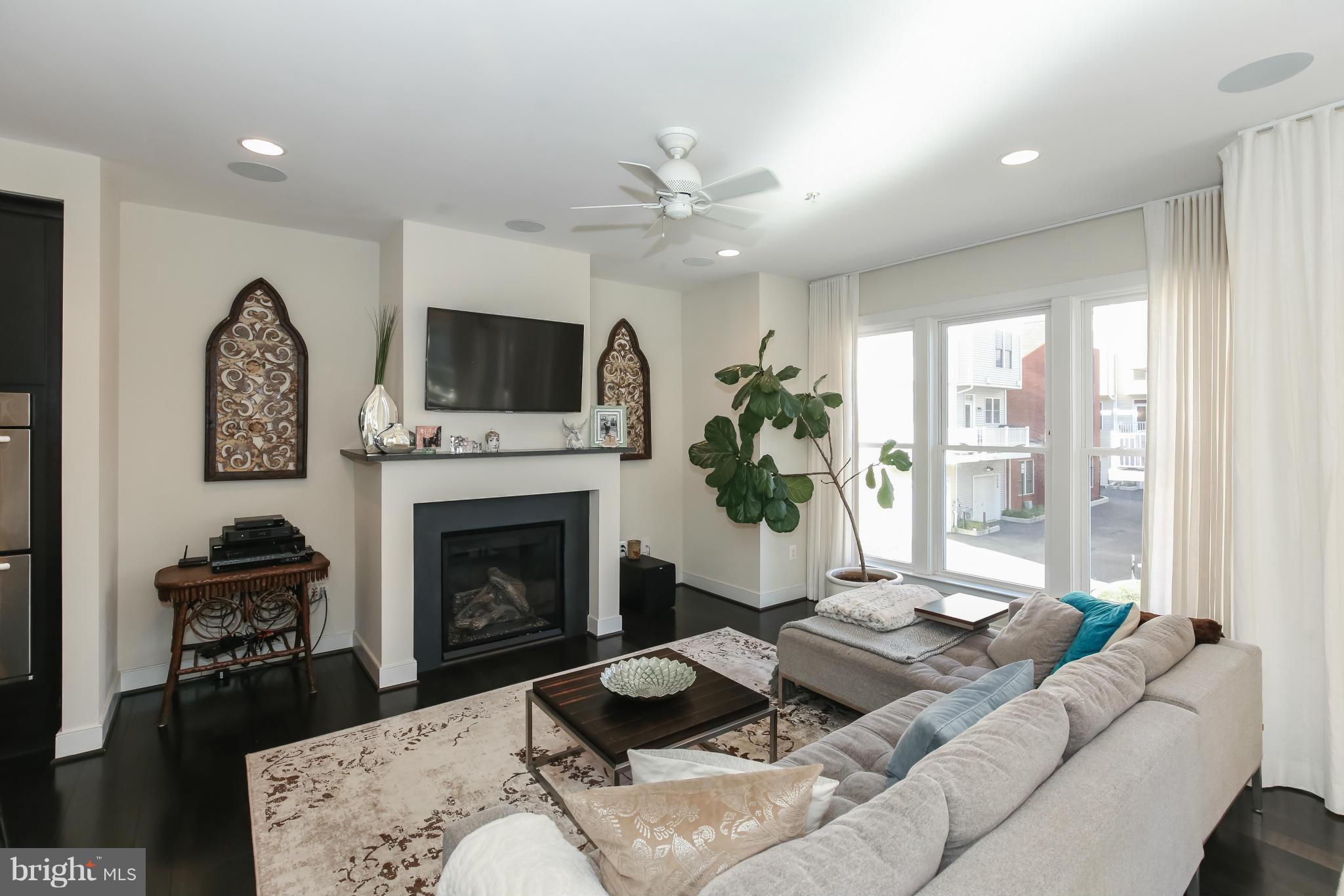 312 L Street Southeast Washington, DC 20003 - Photo 8 of 29 a living room with furniture a fireplace and a flat screen tv