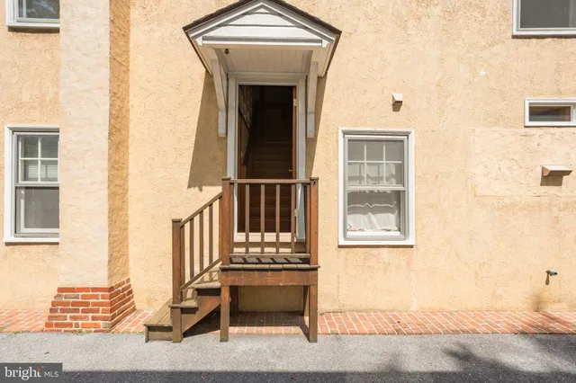 an empty room with wooden floor and a window
