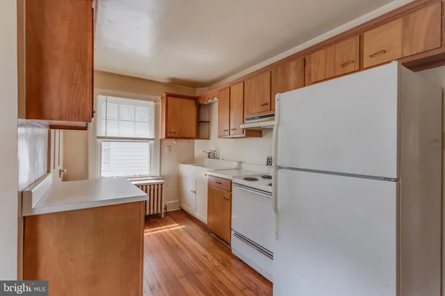 an aerial view of residential house with outdoor space and trees all around