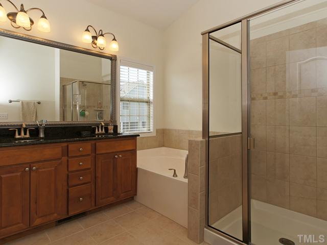 8317 Primanti Boulevard Raleigh, NC 27612 - Photo 12 of 21 SPA STYLE BATH INCLUDES DOUBLE SINKS, GARDEN SOAKING TUB AND OVERSIZED TILED SHOWER!