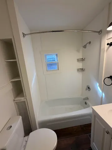 a bathroom with a sink a toilet and a bathtub