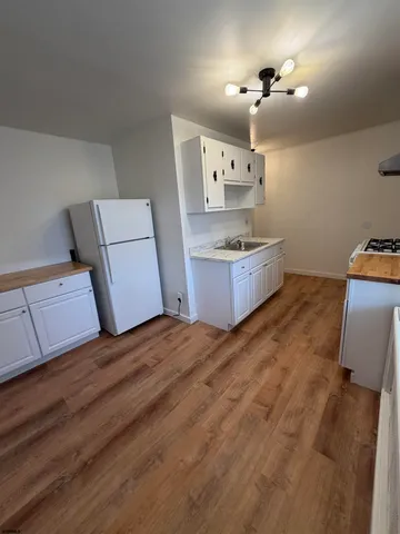 a kitchen with kitchen island sink stove and refrigerator