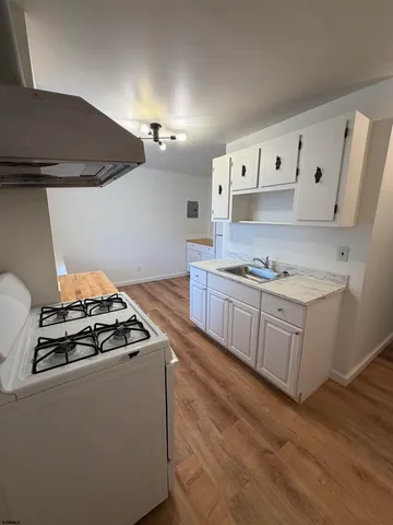 a kitchen with granite countertop a stove and a sink