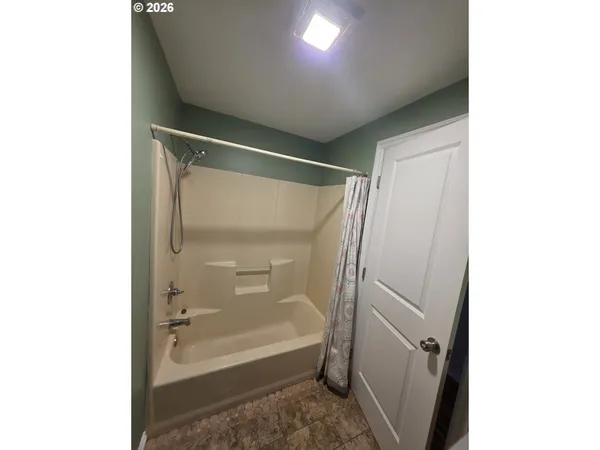 a bathroom with a bathtub and a shower
