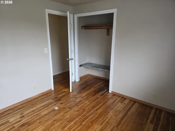a view of a room with wooden floor