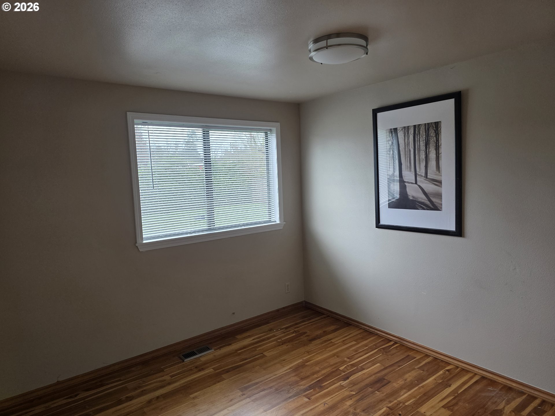 557 South 44th Street Springfield, OR 97478 - Photo 13 of 24 a view of an empty room with wooden floor and a window