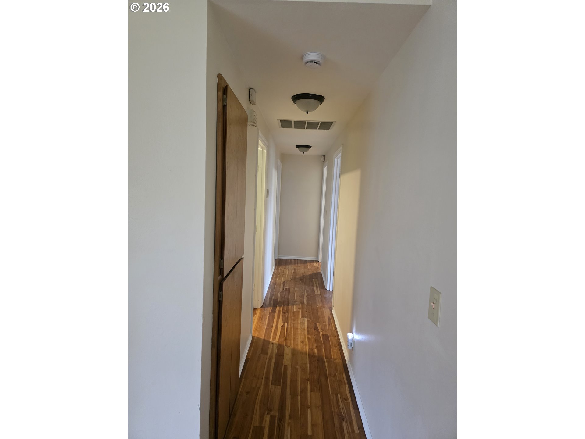 557 South 44th Street Springfield, OR 97478 - Photo 14 of 24 a view of a hallway with wooden floor and a bathroom