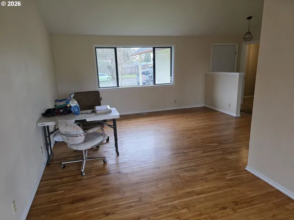 a workspace with wooden floor and a window