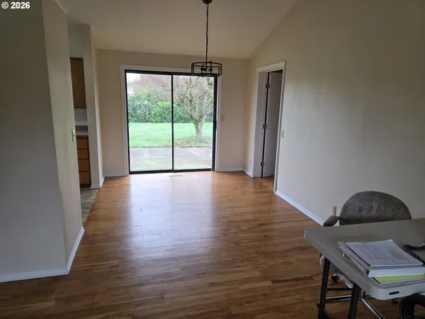 a view of a room with wooden floor and a window