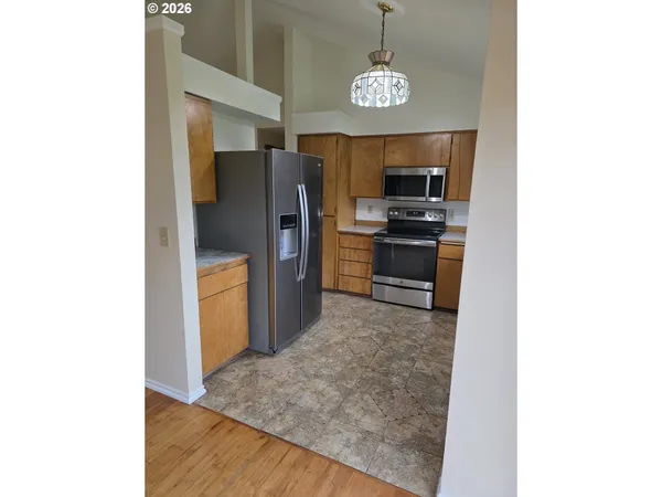 a kitchen with stainless steel appliances granite countertop a refrigerator and a sink