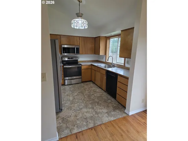 a large kitchen with a stove a sink and dishwasher