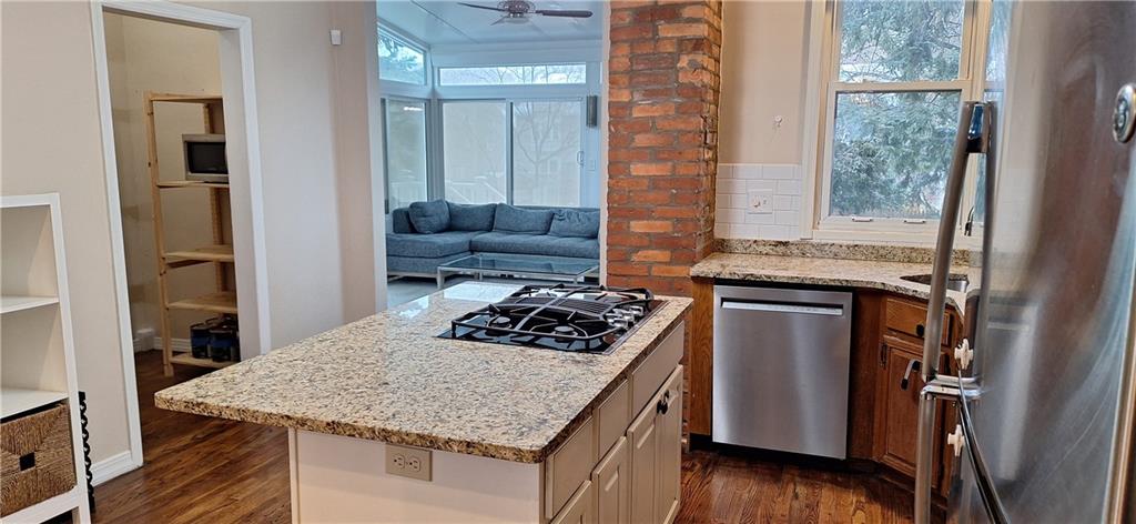 548 South Graham Street Pittsburgh, PA 15232 - Photo 11 of 49 a kitchen with a stove a sink a refrigerator and wooden floor