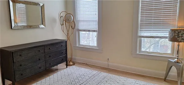 a view of a livingroom with wooden floor and a window