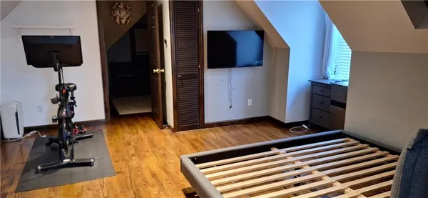 a hallway with a wooden floor and a cabinet