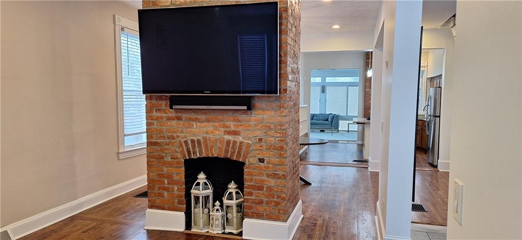548 South Graham Street Pittsburgh, PA 15232 - Photo 4 of 49 a living room with a fireplace and a wooden floor