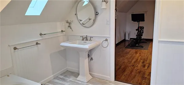 a bathroom with a white bath tub and sink