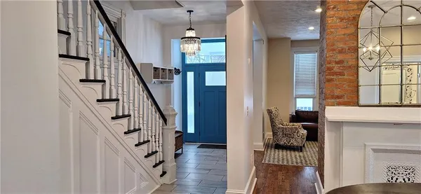 a view of entryway and hall with wooden floor