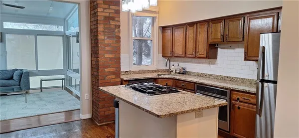 a kitchen with a stove a sink and a refrigerator