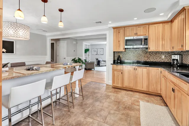 a kitchen with stainless steel appliances kitchen island granite countertop a sink and cabinets