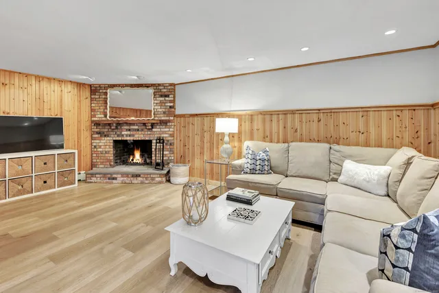 a view of a swimming pool with a yard and large trees