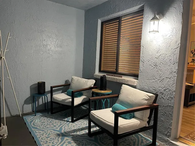 a balcony with table and chairs