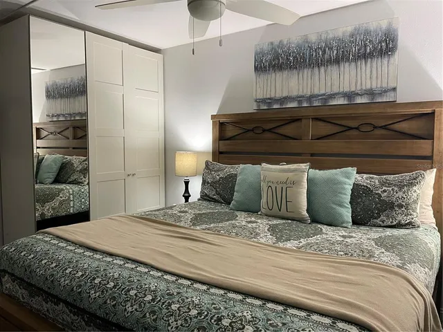 a bedroom with a bed and a mirror