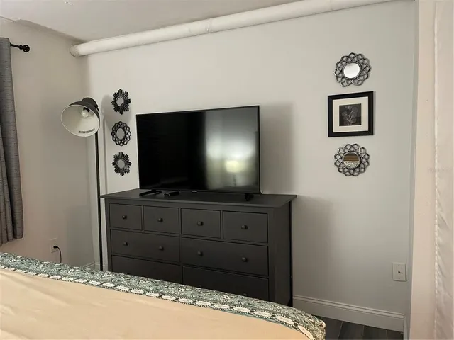 a room with a bed and a flat screen tv